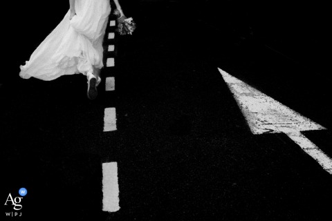 The city hall of Nantes, France, is the backdrop for this artful detail photograph showing the bride-to-be in motion, her wedding shoes and gown visible as she walks toward the town hall.