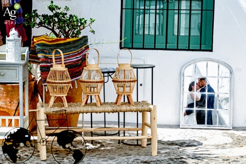 The couple stands for a stylized portrait in the whitewashed streets of Frigiliana, Málaga, showcasing the traditional charm of this southern Spanish village setting.
