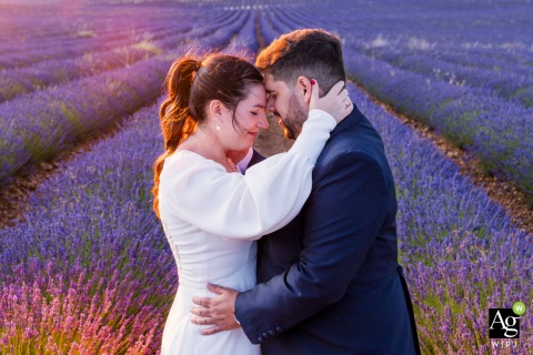 The couple pose for an artistic wedding portrait amidst the lavender fields of Brihuega, Guadalajara, captured by a professional photographer from the Andalusia region of Spain.