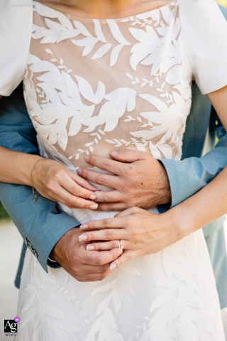 An elegant detail shot at Chateau de Courban shows the wedding rings being placed on each other's hands, highlighting the intricate bands and the significance of the exchange as a symbol of their union.