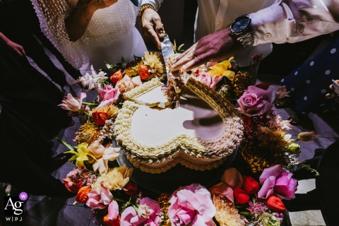 Parma Sole, Istanbul wedding details show the elaborate cake and the bride and groom's hands cutting it together