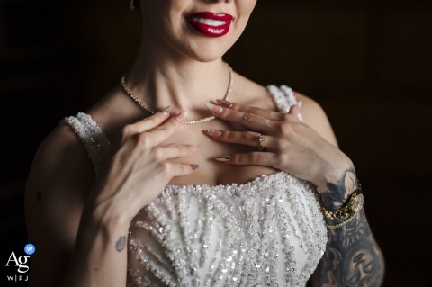 At Zephyr Palace, Villa Caletas Hotel in Jaco, Costa Rica, a stunning detail shot captures the bride's elegant hands and necklace, beautifully showcasing her wedding day jewelry while she prepares.