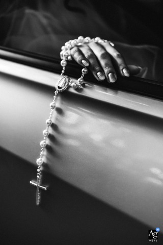 The delicate silver and pearl rosary, a significant Maceió detail from the bride's wedding accessories, is photographed artistically.