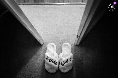 Slippers Rest at Sunny Threshold, Villa Dolceacqua, Oggiono, Lake Como, Italy The bride's slippers rest on the ground at the sun-drenched threshold of a doorway at Villa Dolceacqua, Oggiono, Lake Como, Italy, highlighting a quiet detail of the wedding day.