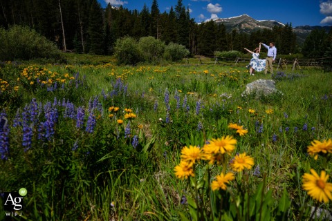Following their morning elopement in Breckenridge, Colorado, a joyful couple dances together amidst a vibrant field of wildflowers before attending their large wedding reception later that same day.