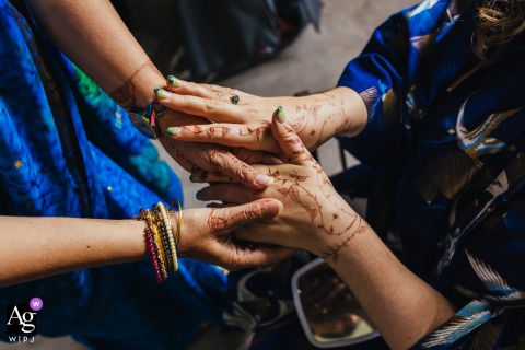 Bride Displays Intricate Henna To A Friend During Morning Wedding Preparations At Holme Pierrepont Hall In Nottinghamshire Bride displays intricate henna to a friend during morning preparations at Holme Pierrepont Hall.