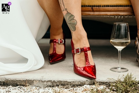 At Ca Freschi Relais In Forlì, Italy, A Close-Up Showcases The Bride’s Dazzling Red Shoes As A Striking Wedding Detail At Ca Freschi Relais in Forlì, Italy, a close-up highlights the bride’s dazzling red shoes, their lustrous finish providing a striking detail for the wedding ensemble.