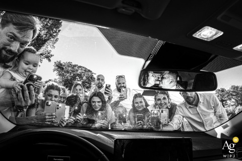 In Gironde, Wedding Guests Snap Photos Of The Couple While The Photographer Captures The Entire Group In A Playful Scene In Gironde, a playful scene unfolds as wedding guests snap photos of the couple, while the photographer captures the entire group in action.