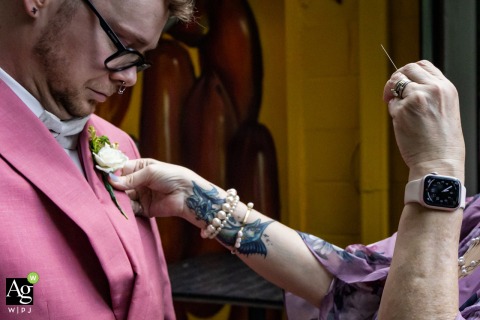 Boutonniere Pinned to Grooms Suit at Reds Beer Garden in Atlanta Georgia During Preparations A boutonniere is pinned to the groom’s suit at Red's Beer Garden in Atlanta, Georgia, capturing a detail from the wedding day preparations.