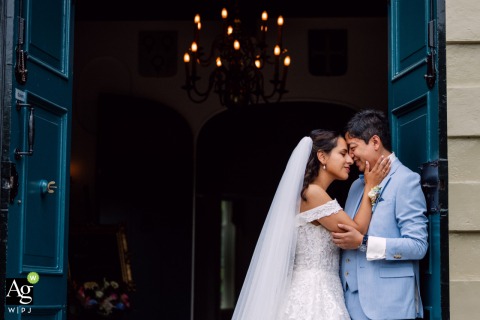 Couple Poses at Kasteel van Rhoon in Netherlands Framed by Classic Ceremony Architecture At Kasteel van Rhoon in the Netherlands, the couple poses together on their wedding day, framed by the classic architecture of the ceremony location.