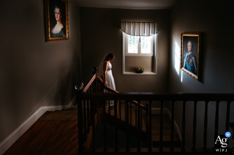 The Bride Descends The Staircase At Château Castlerey In Agen, France, Blending Elegance With Historical Grand Portraits Of Royalty A bride descends the staircase at Château Castlerey in Agen, France, framed by the portraits of Louis XV and his wife, blending elegance with historical grandeur.