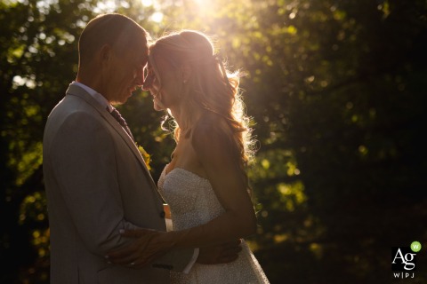 Couple Photographed Head to Head at Sunset at Le Domaine du Clos de Saires Vienne At Le domaine du clos de Saires in Vienne, the couple is photographed head to head at sunset, the subtle light emphasizing the time of day during their portrait.