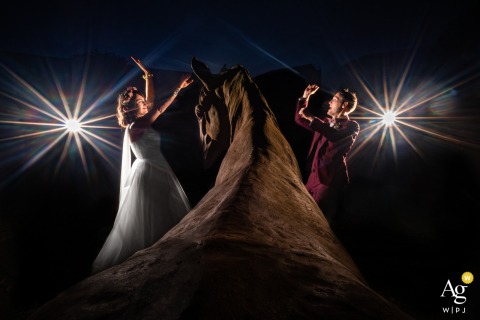 At Domaine de Fontchaudière In Charente, The Couple Dances Joyfully In Front Of A Majestic Horse Statue Amid Wedding Festivities At Domaine de Fontchaudière in Charente, France, the couple shares a joyful dance in front of a majestic horse statue, blending elegance and movement in their wedding celebration.