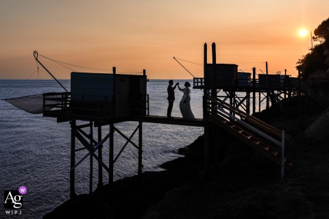On A Carlet At Meschers sur Gironde, The Couple Is Photographed Together With Sweeping Waterside Views On a carlet at Meschers sur Gironde, the wedding couple is photographed together, their portrait set against the sweeping waterside views of this scenic location.