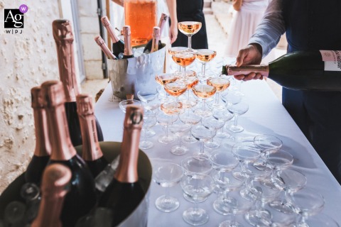 In Their Home In Brantôme-en-Périgord, Dordogne, The Groom Tends To A Champagne Fountain For A Celebratory Wedding Toast In the newlyweds’ home in Brantôme-en-Périgord, Dordogne, the groom tends to a champagne fountain, marking a celebratory detail in the comfort of their residence.