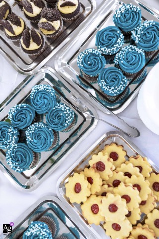 Inside The Reception Venue In Budapest, Colorful Cupcakes And Cookies On Silver Trays Highlight The Sweetness Of Wedding Celebration Inside the reception venue in Budapest, an array of colorful cupcakes and cookies arranged on silver trays provides a sweet and festive highlight for the celebration.
