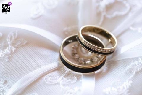 At The Hotel In Budapest, Two Wedding Rings Rest On Intricate Lace, Symbolizing Love And Commitment With Timeless Elegance At the hotel in Budapest, two wedding rings rest gently on intricate lace, symbolizing love and commitment with a touch of timeless elegance.