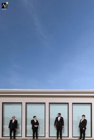Groom Poses With Father and Groomsmen on Back Terrace at The Lakehouse in Halifax Massachusetts On the back terrace of The Lakehouse in Halifax, Massachusetts, the groom poses with his father and groomsmen, marking the occasion with a group portrait at the venue.