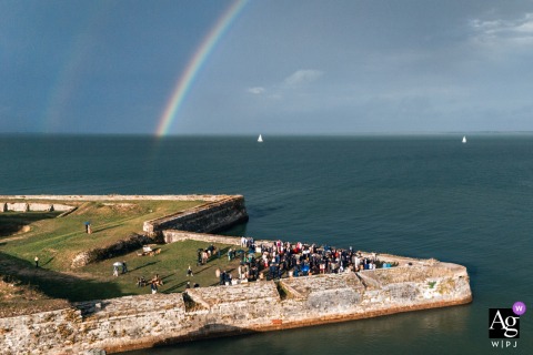 During Cocktail Hour At Fort La Prée On Ile de Ré, Guests Enjoy Rainbow-Colored Cocktail Hour During cocktail hour at Fort la Prée on Ile de Ré, guests enjoy a festive rainbow-colored cocktail hour, adding a lively detail to the celebration by the French coast.