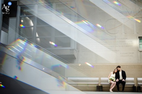   At Civic Center Park in Denver, Colorado, the newlyweds share a peaceful sit on a bench following their wedding at the Denver Courthouse, with city surroundings providing a relaxed touch.