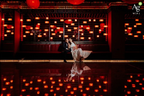 Port of Spain Wedding Couple in a Sea of Lights The couple sits together at their wedding reception venue in Port of Spain amid warm lights.