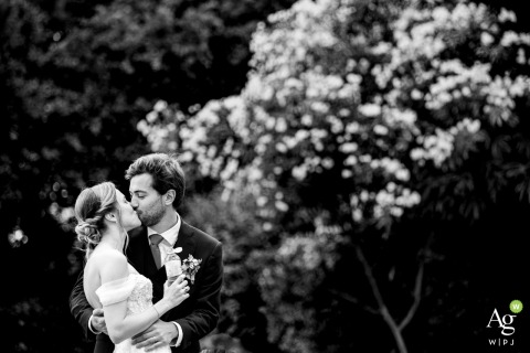 Intimate Black and White Kiss Highlights Couple and Nature Reception at Tir au Vol in Arcachon The couple kisses at the reception venue Tir au Vol, Arcachon, a bw record of an intimate session during wedding festivities.