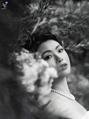 Black-And-White Portrait Of The Bride At Sinan Salon In Shanghai, Framed By Foliage And Floral Accents For Graceful Effect At Sinan Salon in Shanghai, a black-and-white portrait features the bride, framed by soft foliage and floral accents for an elegant, graceful effect.