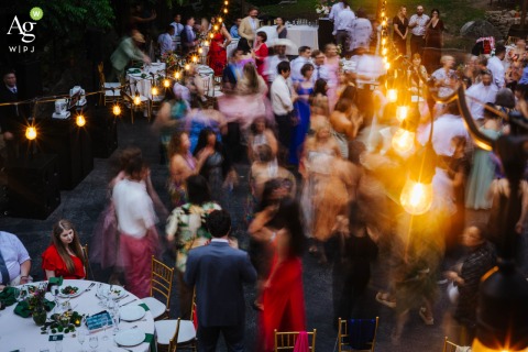 Guests Captured in a Blurred Dance Celebration in the Courtyard at Arrow Park in New York At Arrow Park in New York, guests are captured mid-dance in the courtyard, their movements blurred by long exposure during the wedding reception.