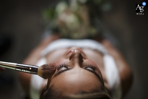 Close-Up Detail Captures The Bride Receiving Makeup At Hacienda Sitio De Mata In Pavones Turrialba, Costa Rica At Hacienda Sitio de Mata in Pavones Turrialba, Costa Rica, a close-up detail captures the bride as she receives her makeup during the getting ready process.