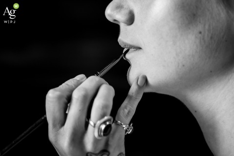 A Makeup Artist Applies Lipstick to Bride Amid Final Preparations in Montagnole Savoie France At Domaine des Saints Pères in Montagnole, Savoie, France, a makeup artist applies lipstick to the bride as final preparations take place before the ceremony.
