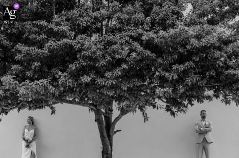 Minimal And Modern Portrait Of The Bride And Groom Framed Beneath Tree Branches In Puerto Morelos, Mexico In Puerto Morelos, Mexico, a minimal and modern portrait frames the bride and groom beneath the branches of a tree.