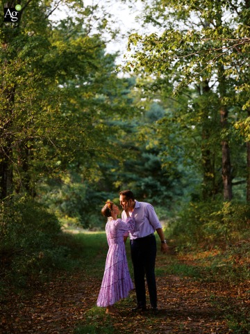 Couple Shares a Kiss Along The Old Tote Road at The Hop Yard in Gorham Maine The couple is kissing along The Old Tote Road at The Hop Yard in Gorham, Maine, rustic charm and natural beauty surround the celebration, marking the wedding with a sense of tradition and community.