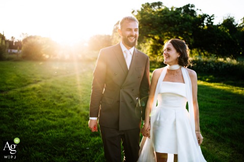 Golden Sunset Highlights Couple’s Warm Affection Against Countryside at Talton Lodge in Warwickshire Bathed in the golden light at Talton Lodge in Warwickshire, a couple is highlighted against a country landscape, their portrait reflecting warmth and affection at sunset.