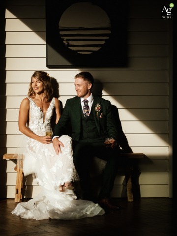 Embracing Couple Basks in Midday Sun and Natural Light Near Tunnels Beaches in Devon UK Near the sands of Tunnels Beaches in Devon, UK, the seated couple embraces beneath the bright midday sun, warmth and natural light emphasizing the love they share.