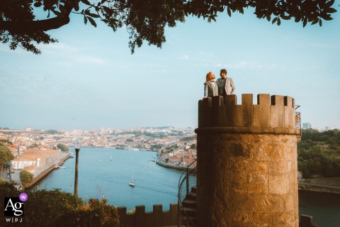 An Elopement Couple Enjoys Solitude Amid Lush Gardens Of Palacio De Cristal In Porto, Portugal, Surrounded By Water And Peaceful Greenery Amid the lush Palacio de Cristal gardens in Porto, Portugal, an elopement couple enjoys time alone, surrounded by greenery and the peaceful atmosphere of the park.