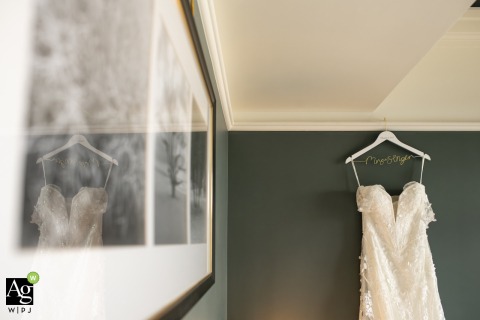 Elegant Setting Showcases Bride’s Wedding Dress at Perry Lane Hotel in Savannah Georgia The bride’s wedding dress hangs in an elegant setting at Perry Lane Hotel in Savannah, Georgia, the delicate fabric and graceful details displayed before the festivities begin.