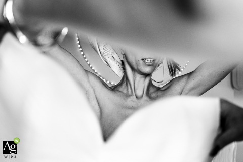 Soft Anticipation Surrounds Bride as She Dresses for Her Wedding at Domaine des Patras France Inside Domaine des Patras, France, the bride is surrounded by soft light and anticipation as she gets dressed in preparation for her wedding day.