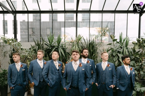 The Groom Stands With Groomsmen Arranged Behind Him Inside The Tinsmith In Madison, Wisconsin, Adding Intensity To The Group Portrait Inside The Tinsmith in Madison, Wisconsin, the groom stands confidently with his groomsmen arranged behind him, their strong expressions adding intensity to the composition.
