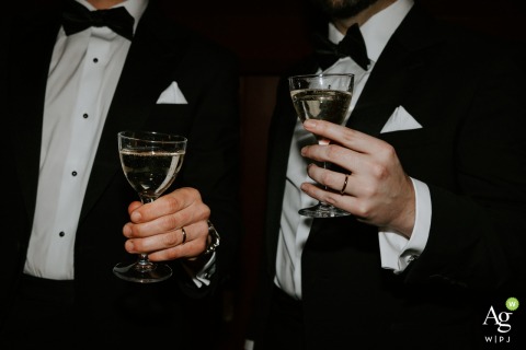 Grooms Savor Champagne and Display Rings Celebrating Together at Hotel Particulier Montmartre in Paris At Hotel Particulier Montmartre in Paris, grooms raise glasses of champagne and display their wedding rings, savoring the joy and romance of their special day together.