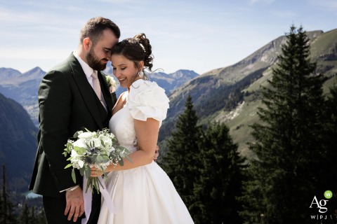 Sweeping Alpine Views Form a Stunning Backdrop During Couple Session in Haute Savoie In the mountain scenery of Haute-Savoie, the couple enjoys a session surrounded by sweeping views, the peaks providing a breathtaking backdrop for their shared celebration.