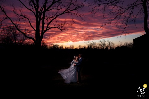   In Leesburg, Virginia, the bride and groom are captured together during a portrait session, with the local landscape providing a serene and intimate backdrop.