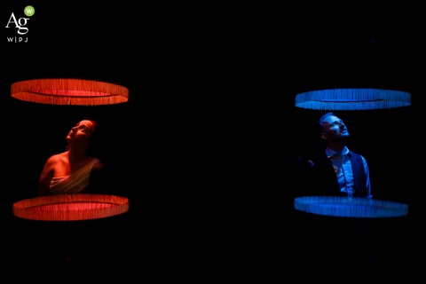 Bold Red and Blue Lights Create Festive Modern Ambience Inside Venue in Zuid Holland Inside the wedding venue in Zuid Holland, bold splashes of red and blue lighting create a dynamic and graphic environment, emphasizing the modern and festive atmosphere.