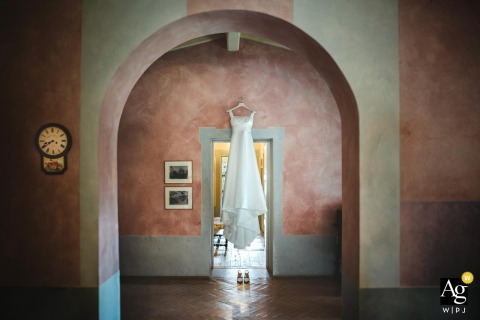 Evocative Scene At Badia A Coltibuono In Tuscany Highlights The Abbey’s Ancient Beauty And The Bride’s Timeless Gown Design At Badia a Coltibuono in Tuscany, an evocative scene highlights both the ancient abbey and the sense of timelessness woven into the brides dress.