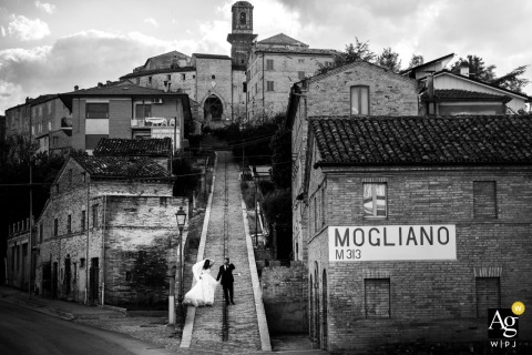   Mogliano sets the scene for a wedding portrait amid a deserted cityscape, its empty streets and distinctive architecture offering a unique and atmospheric backdrop.