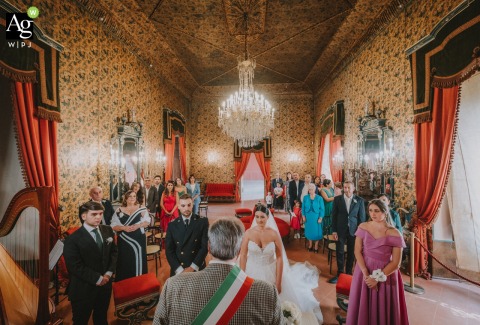 Ceremony Transforms Museo Civico Di Lucera Grand Hall Into Artistic Stage In Foggia Italy Inside Museo Civico di Lucera, meticulous symmetry, bold color, and perspective blend as a formal civic wedding ceremony transforms the grand hall into an artistic stage.