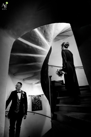 Newlywed Couple Embraced By Grand Spiral Staircase Inside Schloss Westerburg Westerburg Germany Inside Schloss Westerburg, Westerburg, a newlywed couple is enveloped by the castle's grand architecture and spiral staircase, drawing attention to timeless elegance and romance.