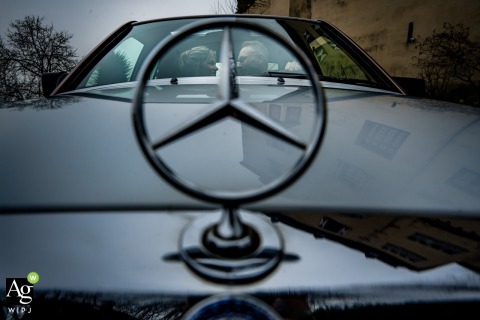 Mercedes Hood Ornament Adds Classic Refinement At Schloss Westerburg Germany Wedding Day At Schloss Westerburg in Germany, a stylish portrait features a Mercedes hood ornament, adding a touch of classic refinement to the wedding day’s atmosphere.