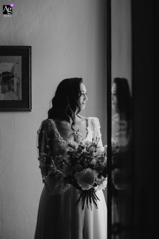   An artistic bride’s portrait at Château l'Hermitage de Combas features creative reflections, adding depth and intrigue to the composition against the backdrop of the chateau.