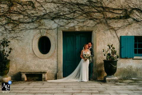 Private, Knowing Glance Shared By The Couple In Front Of Domaine Du Petit Malherbes, Estate Building Framing The Connection Domaine du petit Malherbes features the couple enjoying a private, knowing glance in front of the estate’s main building, the classic architecture framing their connection.