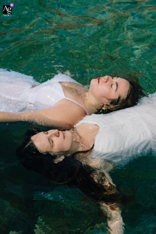 The Couple Takes A Refreshing Break Lying In The Sea Along A Marseille Beach Wedding Venue Along a Marseille beach chosen as the wedding venue, the couple lie in the water, pausing for a refreshing break between the civil and symbolic ceremonies.